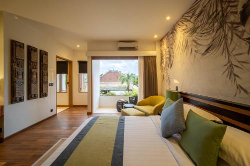 a hotel room with a bed and a window at Villa Artisane in Seminyak