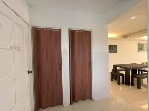 two sliding doors in a room with a table at SIREH Cozy Homestay Jln Garuda TelokPanglimaGarang in Teluk Panglima Garang