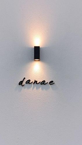 a light on a wall with a name on it at Aphrodite Luxury Suites with private heated pools in Kos Town