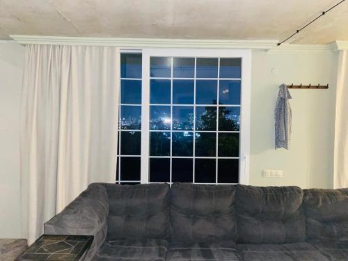 a living room with a couch in front of a window at Sweet Lemon in Batumi