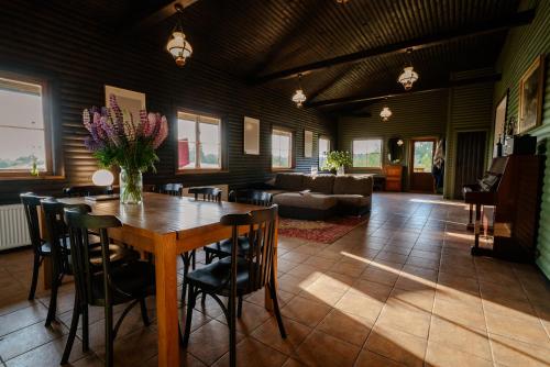 a living room with a wooden table and chairs at Grava Cottage in Tukums