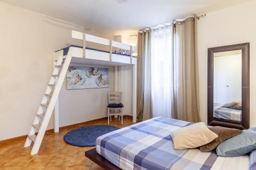 a bedroom with a bunk bed and a ladder at La Casa Rossa Versilia in Camaiore