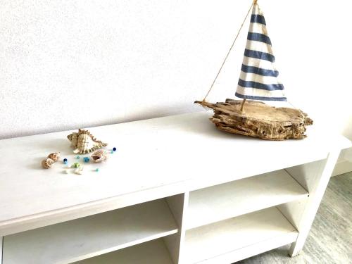 a white table with a toy boat on it at La Coccinella Residence in San Vincenzo