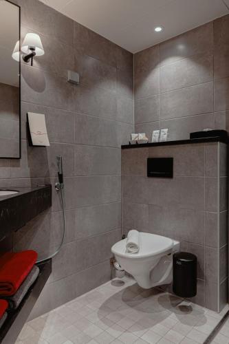 a bathroom with a toilet and a shower in it at Original Sokos Hotel Vaakuna Mikkeli in Mikkeli