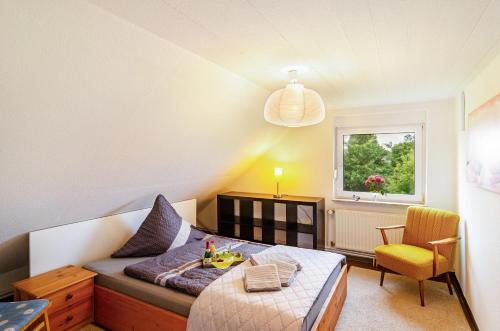 a bedroom with a bed and a desk and a window at Ferienhaus Lüttje Dörp in Blomberg