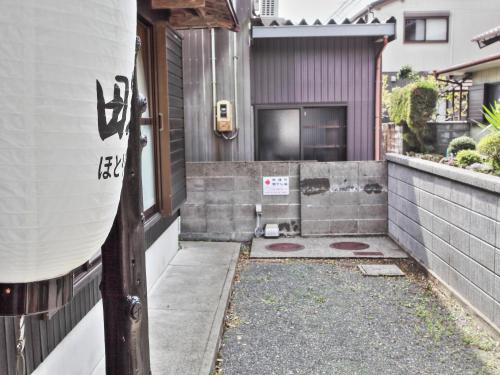 an entrance to a house with a door at ゲストハウス 畔（hotori） in Nishimukai