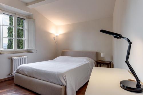 Postel nebo postele na pokoji v ubytování Casa delle Rose - Fiesole