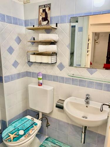a bathroom with a sink and a toilet and a mirror at Casetta Ambretta in Monterosso al Mare