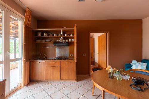 a kitchen with a table and a dining room at Loano 2 Village in Loano