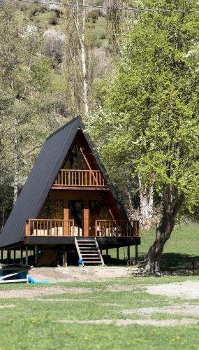 a large log cabin with a black roof at Phaliani's Heaven in Mestia