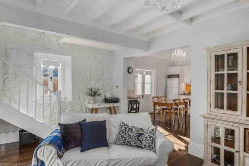 a living room with a couch and a dining room at Warm, Inviting & Luxurious The Barn in Sandy Bay