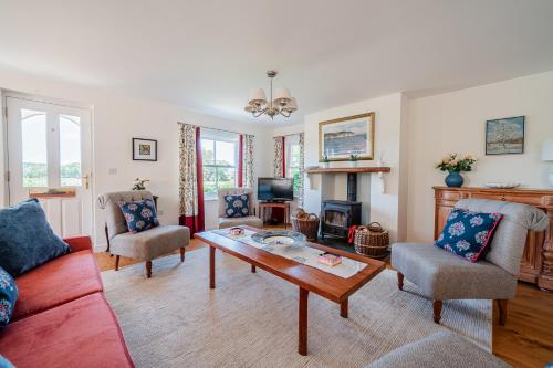 a living room with a couch and a table at Beautiful Cottage in Brockenhurst with Forest View in Brockenhurst