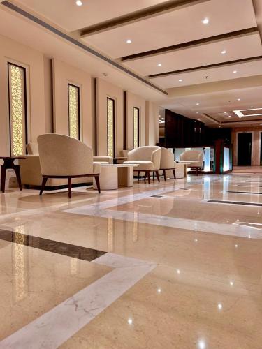 a lobby with chairs and tables in a building at Best Western Plus Amritsar in Amritsar