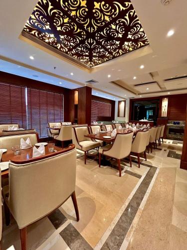 a dining room with tables and chairs and a chandelier at Best Western Plus Amritsar in Amritsar