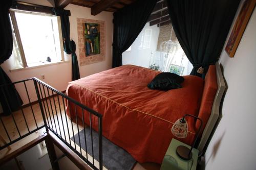 a bedroom with a bed with an orange blanket at Casa Letizia in Brtonigla