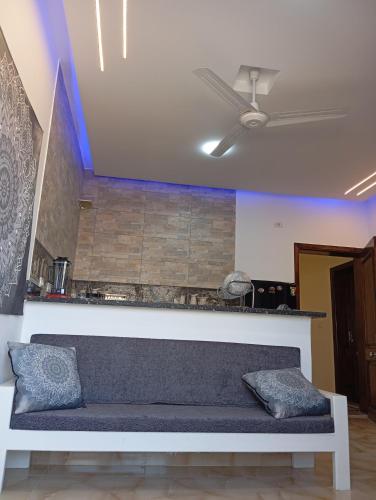 a couch in a living room with a ceiling fan at Villamar Sea View rooms & apartments in Hurghada