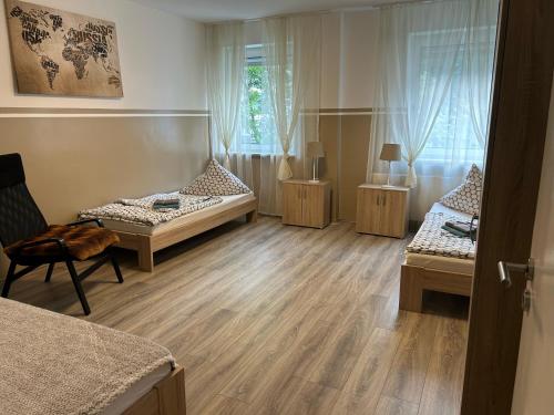a room with three beds and a chair in it at Ferienwohnung in Witten