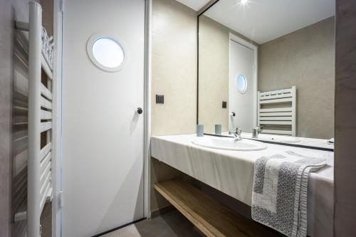 a bathroom with a sink and a mirror at The Dorians in Athens