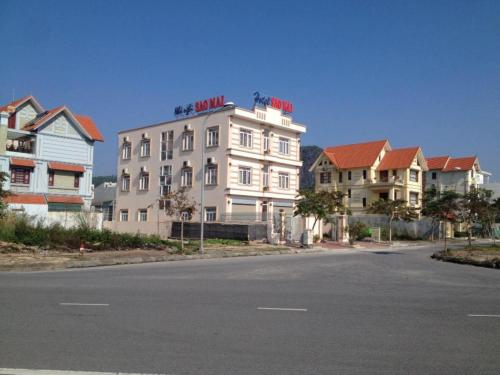a large white building on the side of a street at Sao Mai Hotel Hạ Long in Ha Long