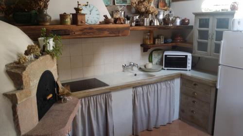 a kitchen with a sink and a stove at La Curva De María in Terán