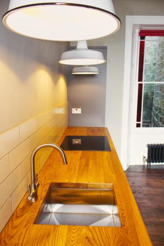 a kitchen counter with a sink and a light at The Artists Retreat - Hastings in Hastings