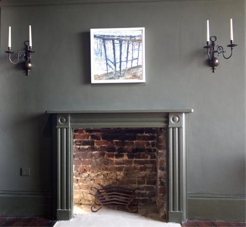 a fireplace in a living room with a picture on the wall at The Artists Retreat - Hastings in Hastings