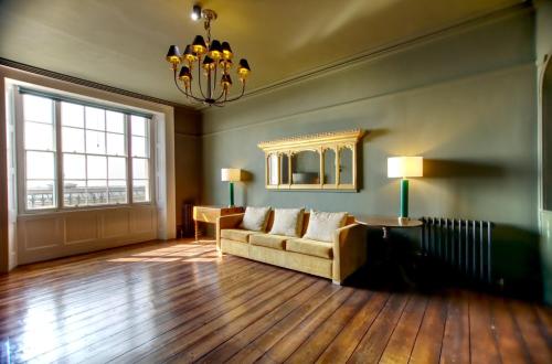a living room with a couch and a large window at The Artists Retreat - Hastings in Hastings