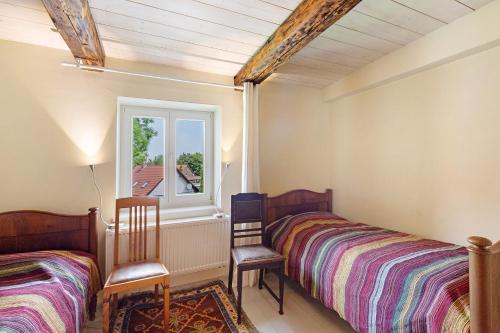 a bedroom with two beds and a window at Altes Pfarrhaus - Durchblick in Hüttenrode