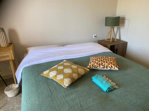 a bed with two pillows on top of it at Pelikastri in Promírion