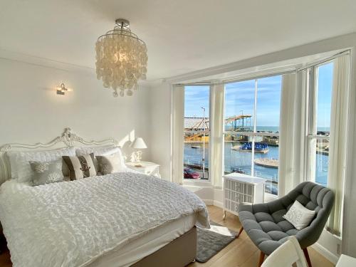 a bedroom with a bed and a large window at The Beach House in Hastings