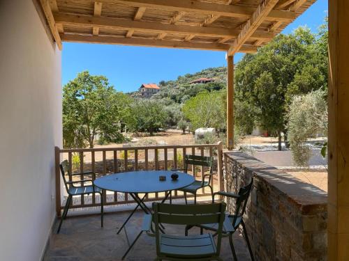 a patio with a table and chairs on a balcony at Pelikastri in Promírion