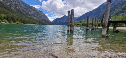 a body of water with mountains in the background at Pension Alpengruss in Heiterwang