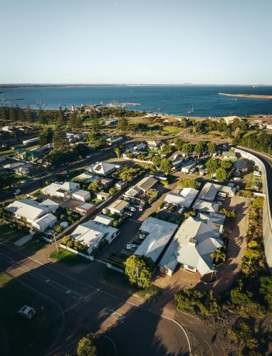 an aerial view of a suburb with houses and the ocean at Esperance Bay Holiday Park in Esperance