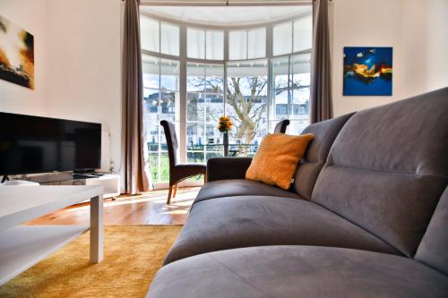 a living room with a couch and a television at 40b Wellington Suites in Hastings