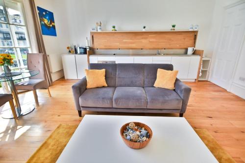 a living room with a couch and a table at 40b Wellington Suites in Hastings