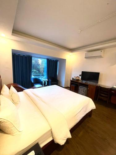 Postel nebo postele na pokoji v ubytování A25 Hotel - 57 Quang Trung
