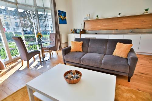a living room with a couch and a table at 40b Wellington Suites in Hastings