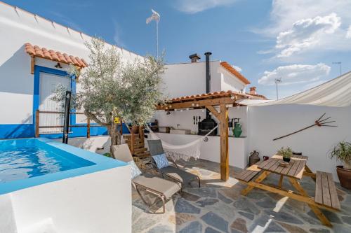 a patio with a swimming pool and a villa at Casa do Tintejo in Motrinos