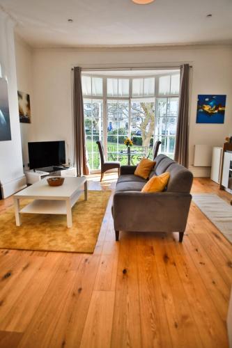 a living room with a couch and a table at 41b Wellington Suites in Hastings