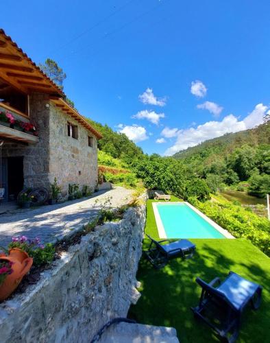 an external view of a house with a swimming pool at Casa da Quinta Costa D'Além Gerês in Terras de Bouro