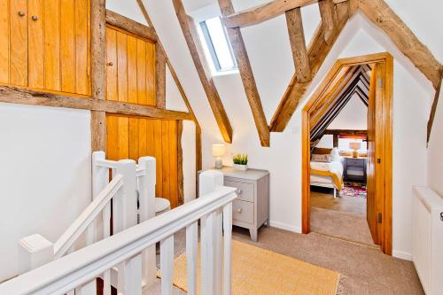 a staircase in a house with wooden beams at The Roost in Battle