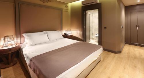 a hotel room with a bed and a dresser at Taksim Premium Hotel in Istanbul