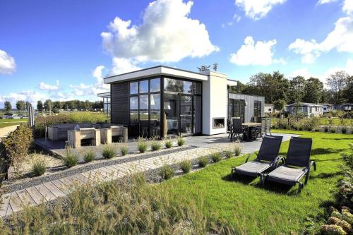 a black and white house with a garden at EuroParcs Bad Hoophuizen in Hulshorst