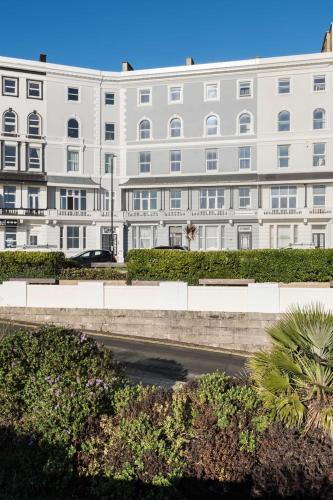 a large white building with a street in front of it at Sea Mist - Hastings in Hastings