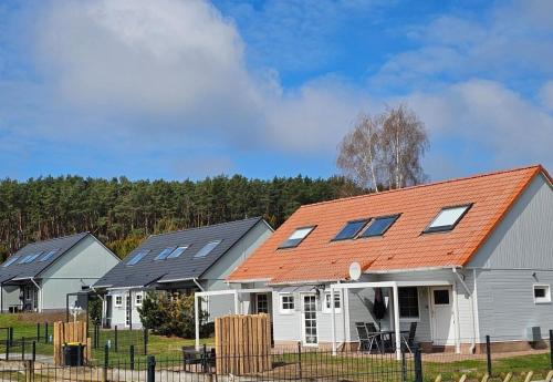 a row of houses with solar panels on them at Familien Ferienhaus Usedom Familie Stopp Haus 25 in Lütow