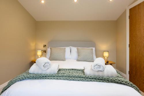 a bedroom with a large bed with towels on it at The Old Cutter Shed in Whitby