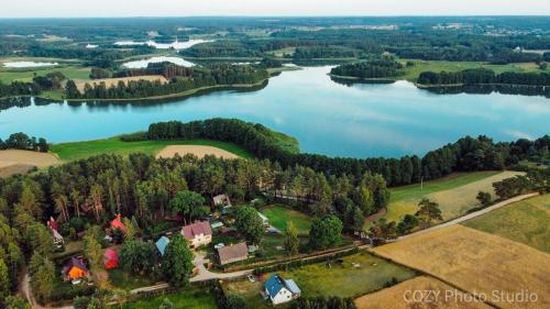 an aerial view of a house on the shore of a lake at Kaszubska Zagroda in Lipuska Huta