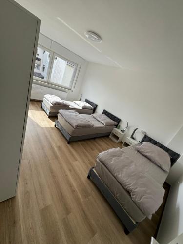 a bedroom with three beds in a room at Monteurzimmer in Düren - Eifel