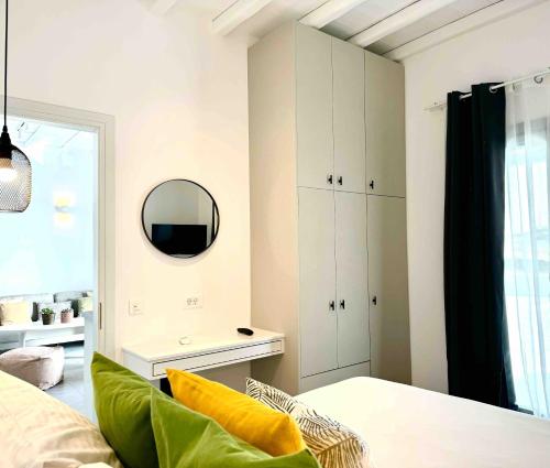 a bedroom with a mirror on the wall and a bed at Almond Place in Dexamenes