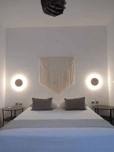 a bedroom with a large bed with two tables at Ραχάτι in Áyios Stéfanos